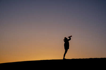 hiker is jumping between rocks at footpathの写真素材