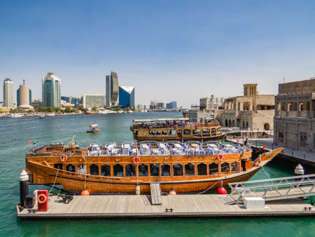 Dubai, United Arab Emirates. Abra - old traditional wooden boat and Grand Bur Dubai Masjid Mosque on the bay Creek.の写真素材