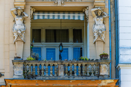 Facade of an old building with a balcony decorated with sculptures, in the historical center of the city. Zagreb. Croatia.の写真素材