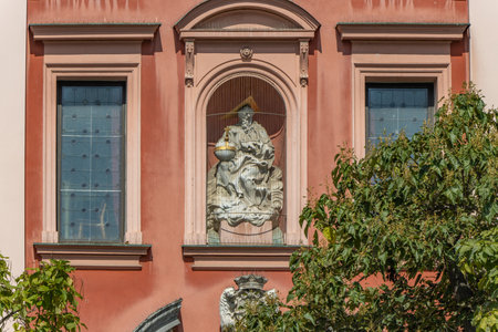 Ljubljana, Slovenia. Red and pink historical Franciscan church of the Annunciation monumental front facade with statue.の写真素材
