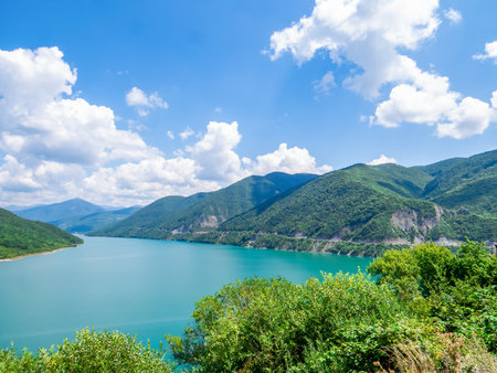 Panorama of Zhinvali Reservoir with turquoise water, surrounded by picturesque Caucasus Mountains on Georgian Military Road. Hydroelectric dam on Aragvi River, Georgia.の写真素材