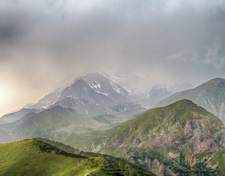 Kazbegi Mountains in the morning surrounding the small town of Kazbegi in Georgia. Trinity Church Gudauri gergeti. Landscape on Kazbegi Mountain in the Greater Caucasus Mountains in Georgiaの写真素材