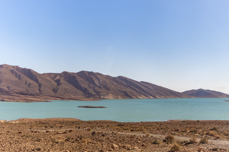 Turquoise blue water in Barrage Al-Hassan Addakhil in dry nature near Errachidia in Moroccoの写真素材