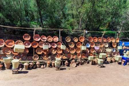 Near Marrakech, Morocco. Colorful market stalls sell traditional handicrafts under historic clay buildingsの写真素材