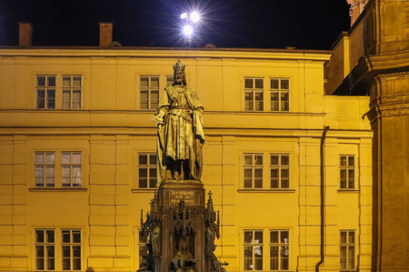 PRAGUE, CZECH REPUBLIC. Cityscape. View of King Charles IV monument at Crusaders' Square in Prague. St. Vitus cathedral at Prague castle in background at night.の写真素材