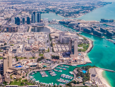 Abu Dhabi. Drone view, near the waterfront, with a marina, boats, and nearby greenery and buildings.の写真素材