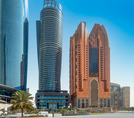 Skyscrapers with futuristic architecture. It's getting dark, attractive lighting. Abu Dhabi, UAE.の写真素材