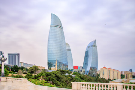 Baku, Azerbaijan. The Flame Towers, stand tall against a vibrant sunset sky. These modern skyscrapers are a symbol of the city's dynamic growth and futuristic vision.の写真素材