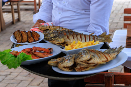 Absheron Peninsula. Plate with three pike-perch fish served in a fishing restaurant in Bibi-Heybat settlement of Baku, Azerbaijan.の写真素材