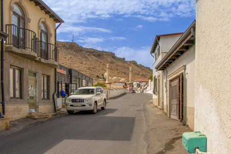 Baku, Azerbaijan. A street in the village of Bibi-Heybat in Baku, Azerbaijan. The rocky, treeless hill in the background, typical of the area, is a characteristic feature of the Absheron Peninsula.の写真素材