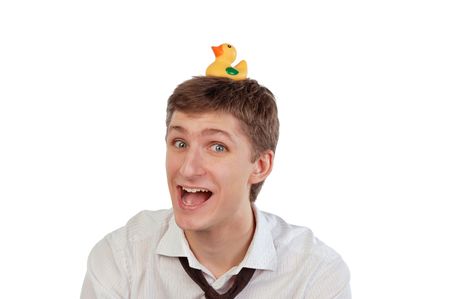 Smiling young man with a rubber duck on his head. Isolated.の写真素材