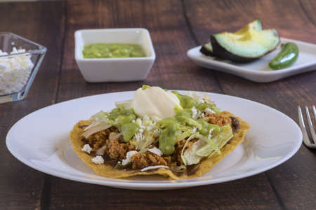 Traditional Mexican food, toast of minced beef with guacamole, lettuce, cream cheese and avocado.の写真素材