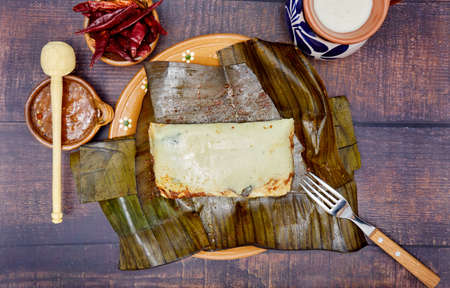 Typical Mexican food, Veracruz or jarochos tamales, prepared with banana leaves, corn flour and red adobo. Prehispanic food, that is, food prepared since before the arrival of the Spanish to Americaの写真素材