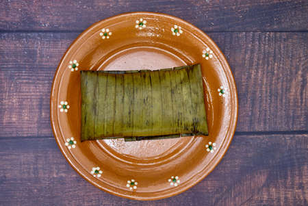 Typical Mexican food, Veracruz or jarochos tamales, prepared with banana leaves, corn flour and red adobo. Prehispanic food, that is, food prepared since before the arrival of the Spanish to Americaの写真素材