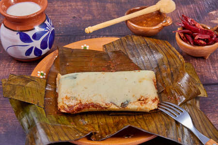 Typical Mexican food, Veracruz or jarochos tamales, prepared with banana leaves, corn flour and red adobo. Prehispanic food, that is, food prepared since before the arrival of the Spanish to Americaの写真素材