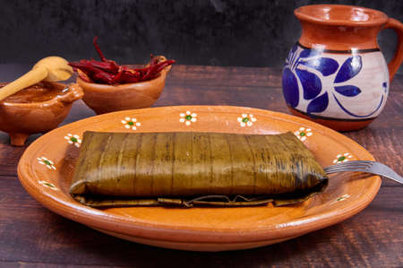 Typical Mexican food, Veracruz or jarochos tamales, prepared with banana leaves, corn flour and red adobo. Prehispanic food, that is, food prepared since before the arrival of the Spanish to Americaの写真素材