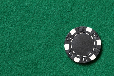 black poker chip on a tableの写真素材