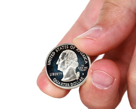 fingers holding quarter dollar coinの写真素材