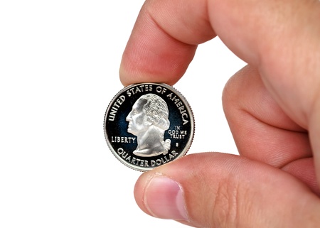fingers holding quarter dollar coinの写真素材