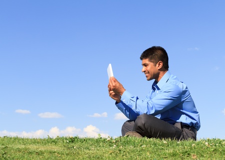 young businessman at the park working with tablet の写真素材