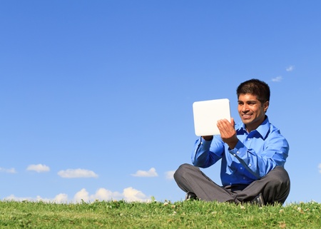 young businessman at the park working with tablet の写真素材