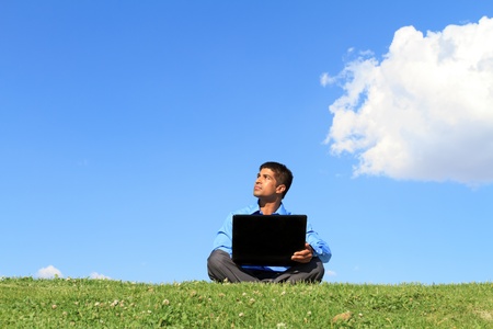 businessman with laptop looking upの写真素材