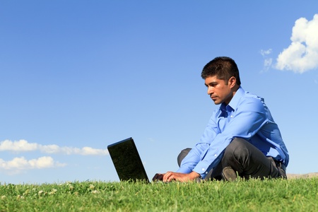 young businessman working at the park の写真素材