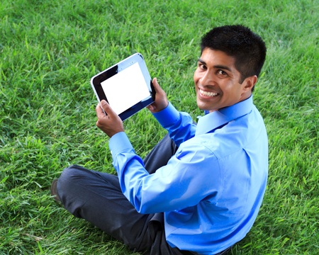 young businessman at the park working with tabletの写真素材