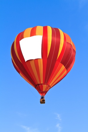 hot air balloon with blank banner over blue sky の写真素材