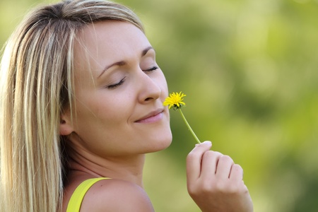 young attractive woman with flowerの写真素材