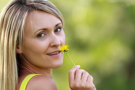 young attractive woman with flowerの写真素材