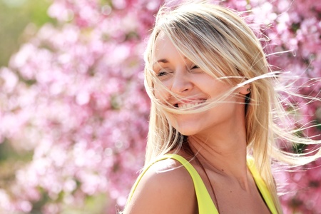 attractive young woman with spring flowersの写真素材