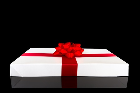 white gift box isolated on the black backgroundの写真素材
