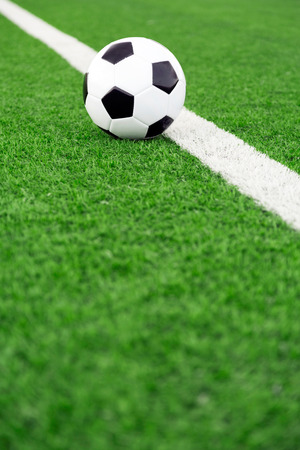 Traditional soccer ball on soccer fieldの写真素材