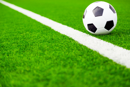 Traditional soccer ball on soccer fieldの写真素材