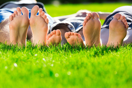 Family relaxing on the grassの写真素材