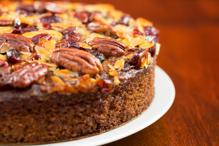 Pecan cake made with sliced almonds and dried cranberriesの写真素材