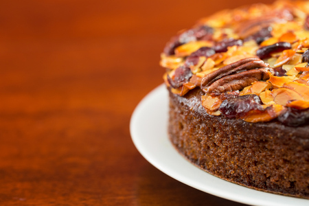 Pecan cake made with sliced almonds and dried cranberriesの写真素材