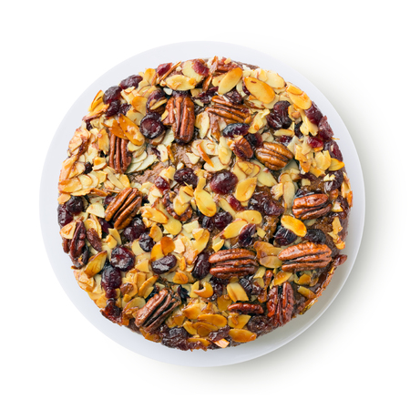 Pecan cake made with sliced almonds and dried cranberries isolated on whiteの写真素材