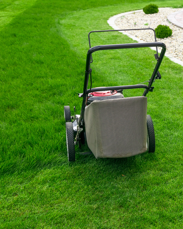 Lawn mower on green grassの写真素材