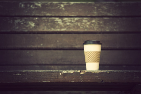 Cup of coffee on wooden benchの写真素材