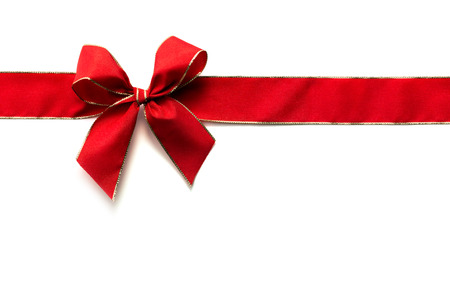 Red ribbon and bow isolated on whiteの写真素材