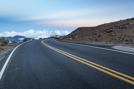 Mountain road above the clouds after sunsetの写真素材