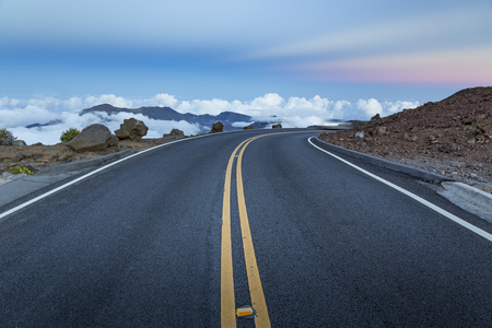 Mountain road above the clouds after sunsetの写真素材