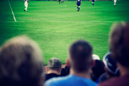 Fans watching soccer game, soccer football fieldの写真素材