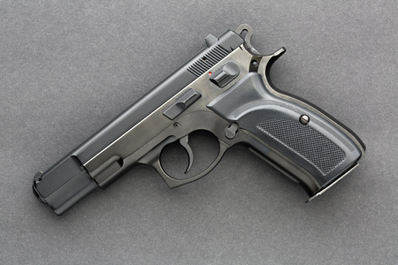 Handgun over dark background photographed from aboveの写真素材