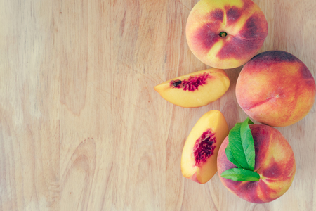 Peaches on wooden background with copy spaceの写真素材