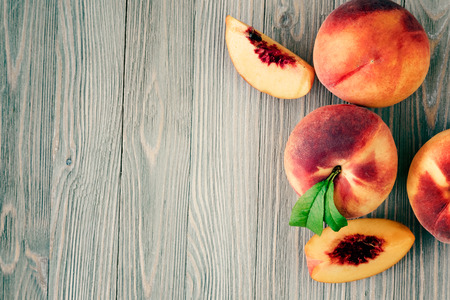 Peaches on wooden background with copy spaceの写真素材