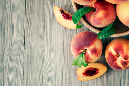 Peaches on wooden background with copy spaceの写真素材