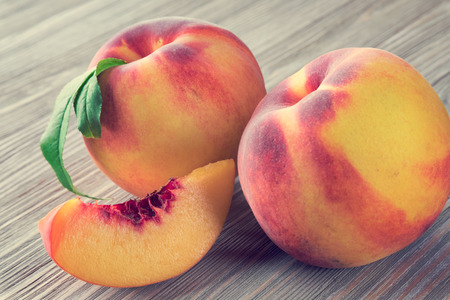 Peaches on wooden backgroundの写真素材